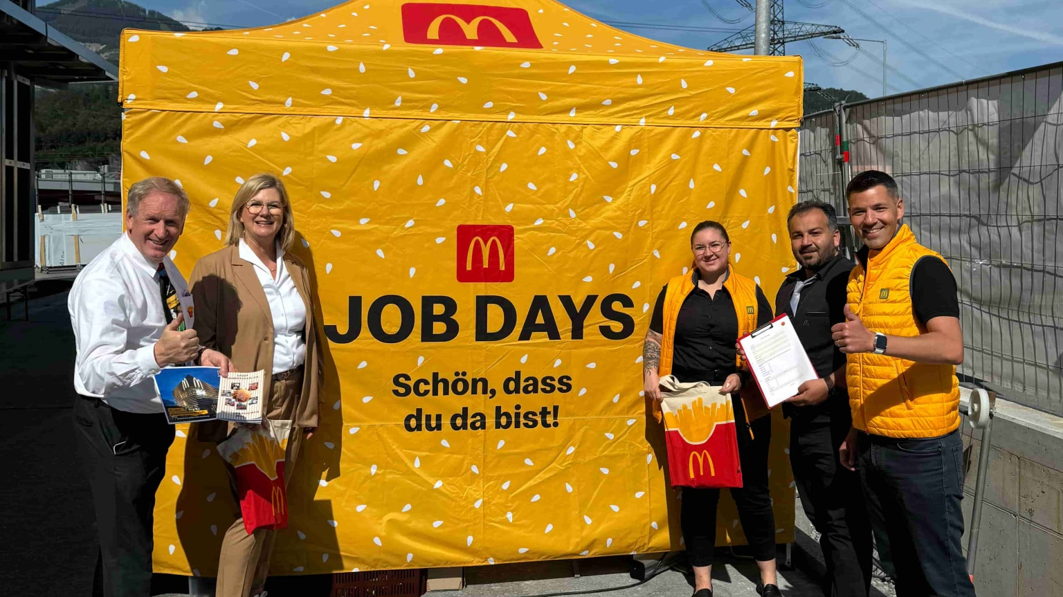 Lächelnde Personen vor dem McDonald’s-Stand beim Job Day in Bürs in Vorarlberg.